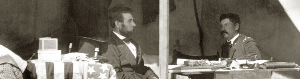 President Lincoln visits General McClellan at his headquarters on October 4, 1862. Visible on the ground at the lower left is a captured Confederate battle flag.