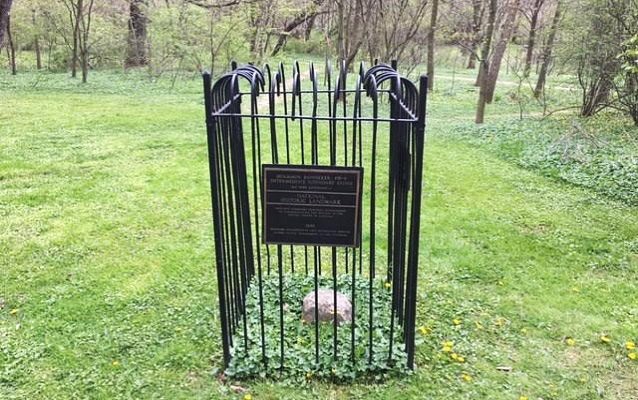 Banneker Boundary Stone with surrounding fence and NHL plaque