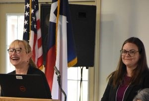 Emily Eig and Kim Daileader Two white women one smiling with blond hair pulled back the other grinning with long brown hair.