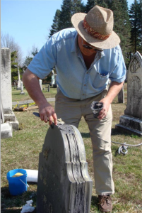 Irving Slavid applies a fill to a delaminated slate.