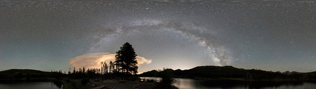 Panorama of the night sky and silhouetted horizon at Rocky Mountain National Park, Colorado.