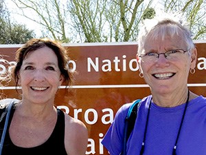 The Devoted People behind Big Data in National Parks Two smiling women stand in front of a national park sign