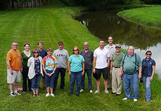 Members of a planning team pose for a group photograph in Johnson Park near the Elkhorn River.