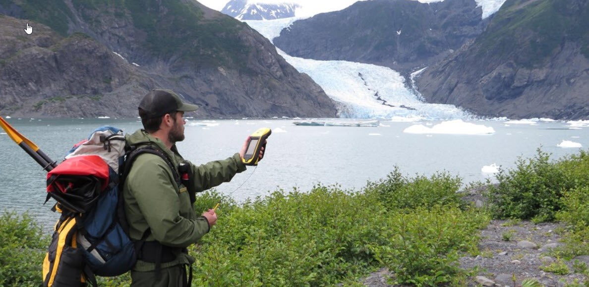 GPS data collection in Alaska A park staffer collecting GPS coordinates near an Alaska glacier
