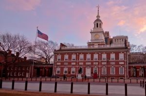 The sun sets behind a Revolutionary War Era building