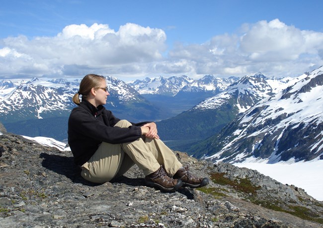 A woman gazes out to the mountains in a moment of quietude.