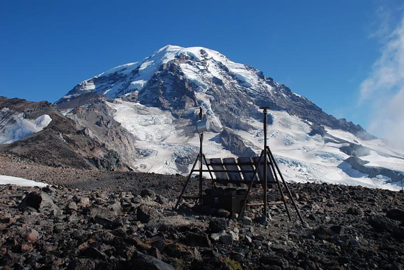 Photo of field instruments on the flank of a snow andice covered mountain.