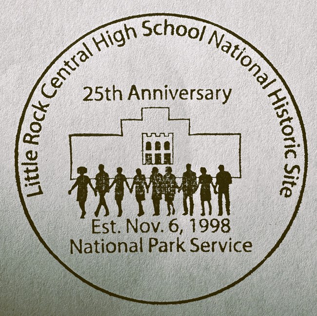 Junior ranger badge reads, "Central High School National Historic Site 25th anniversary 2023" and shows the sihouettes of nine figures walking in front of the main facade at Central High.