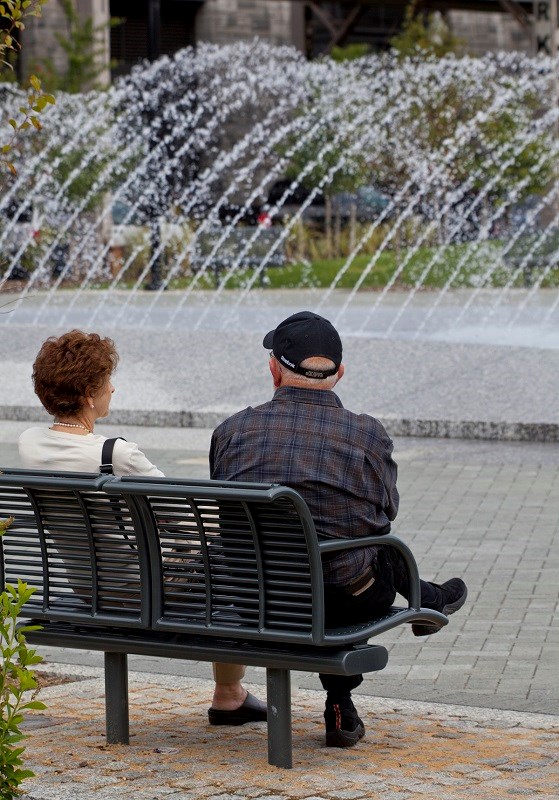 Two visitors sit by the fountains at Georgetown Waterfront Park.