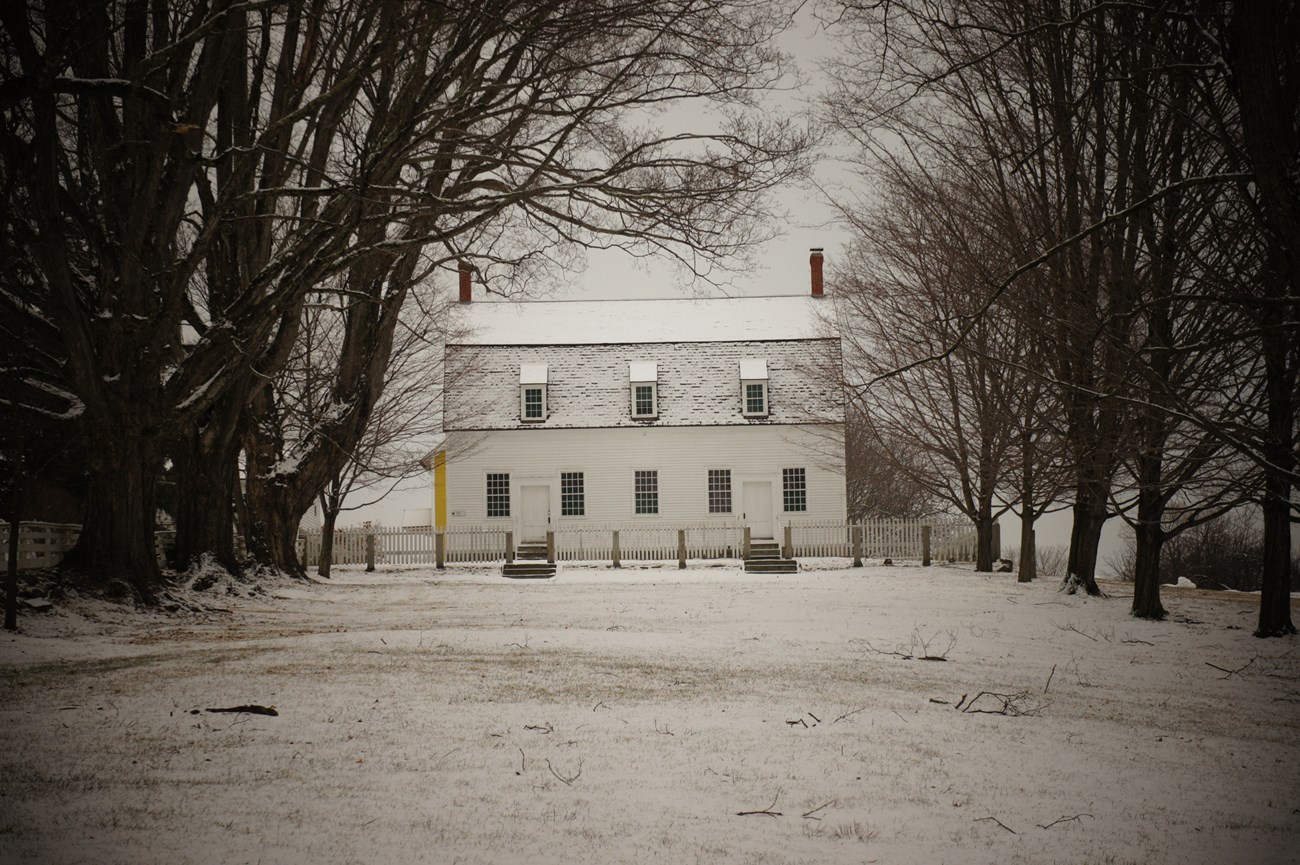 canterbury shaker village long tree flanked common leading to a white clapboard building