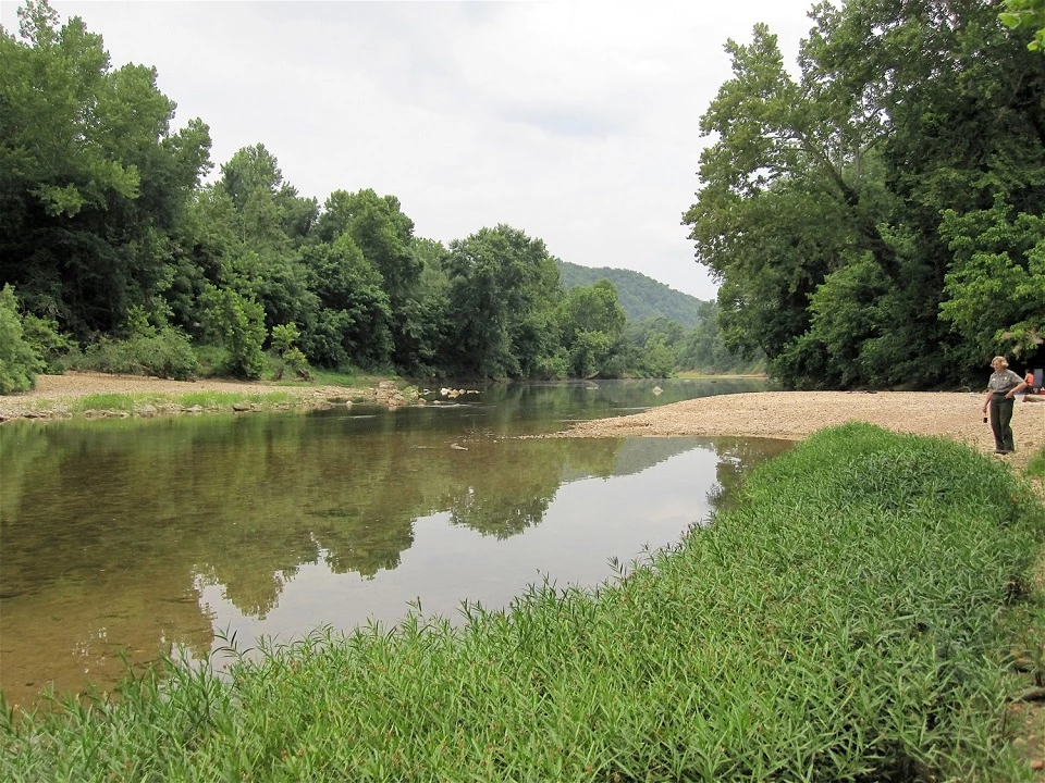 mt. hersey river with green grass and tan gravel at right