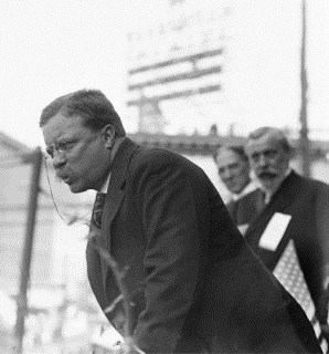 Theodore Roosevelt speaking to a crowd.