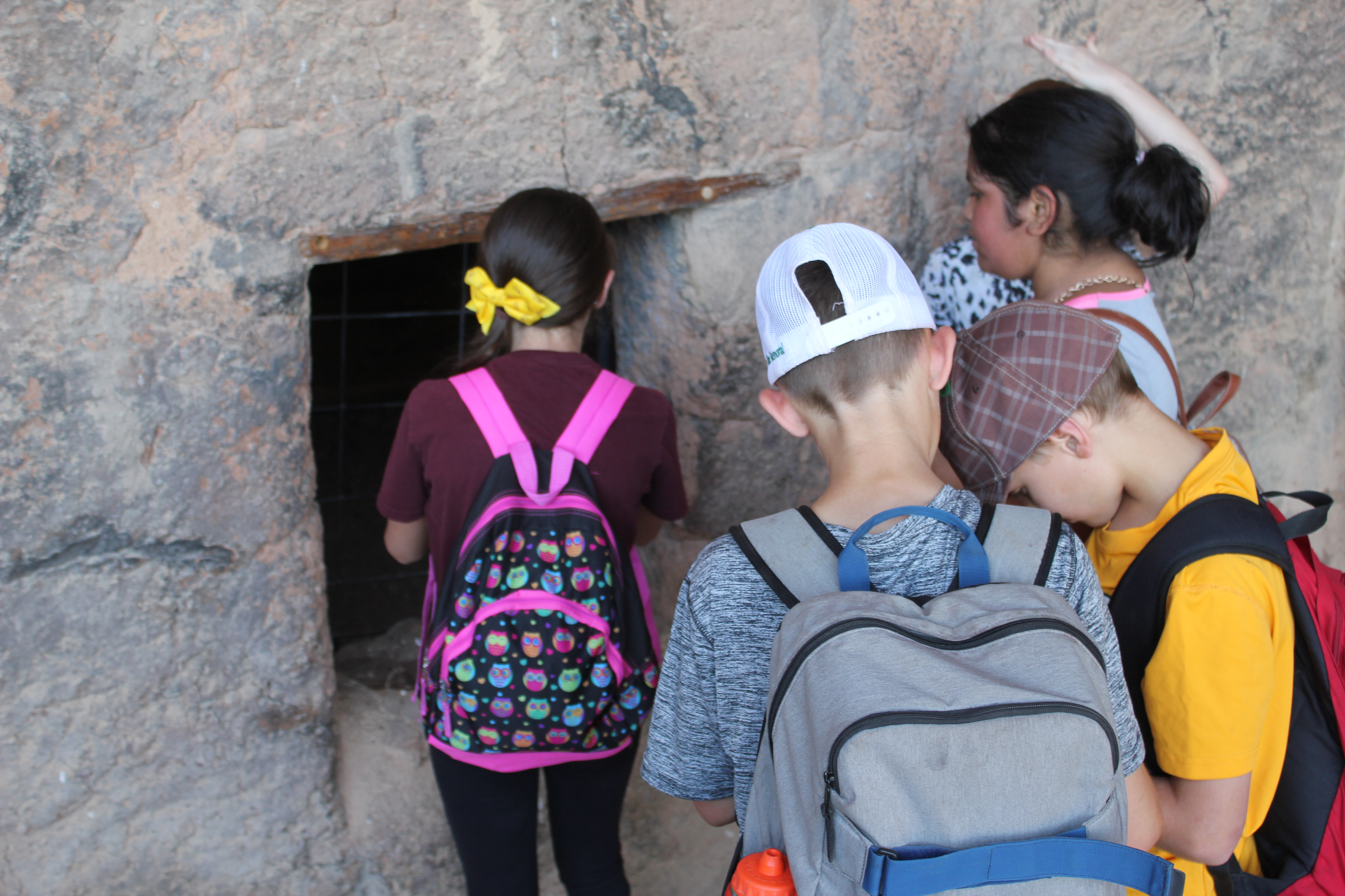 Children looking into Cliff Dwelling rooms.