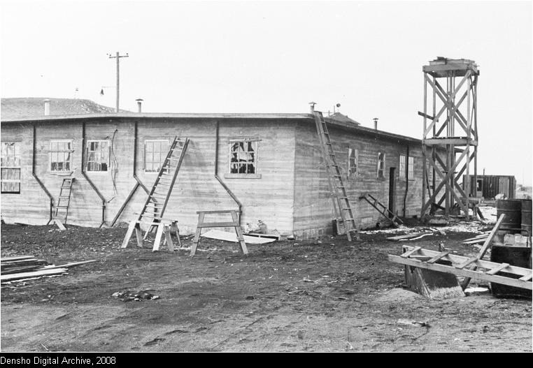 Concrete jail being built with building materials scattered on the ground.