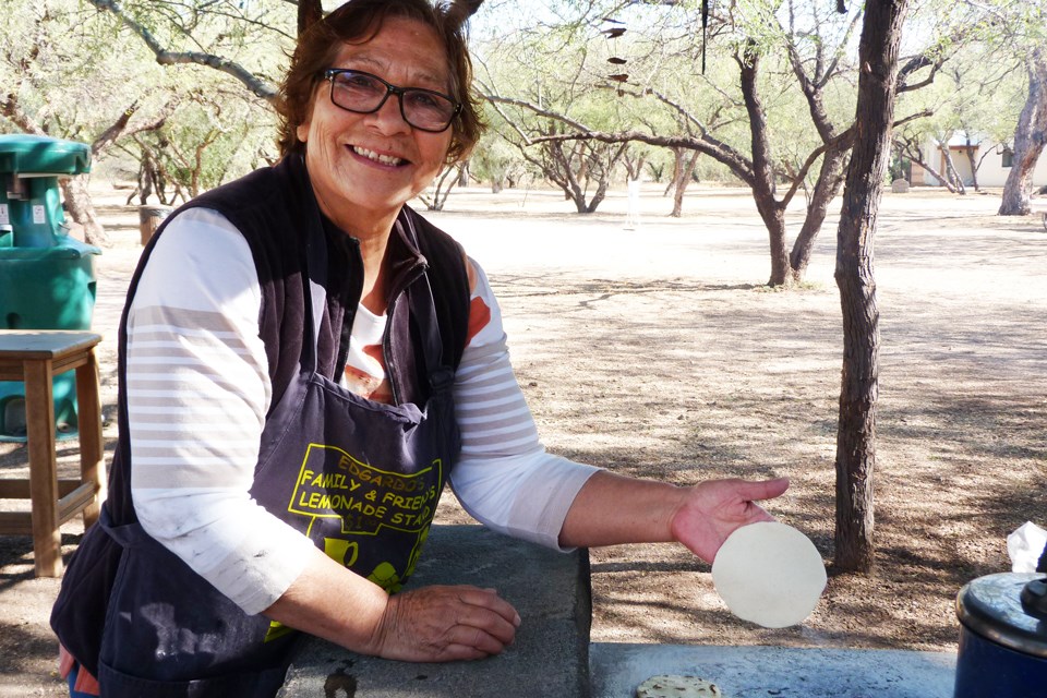 Carolina Arizpe Carolina Arizpe, tortilla demonstrator, out outdoor kitchen with corn tortilla ready to place on the comal.