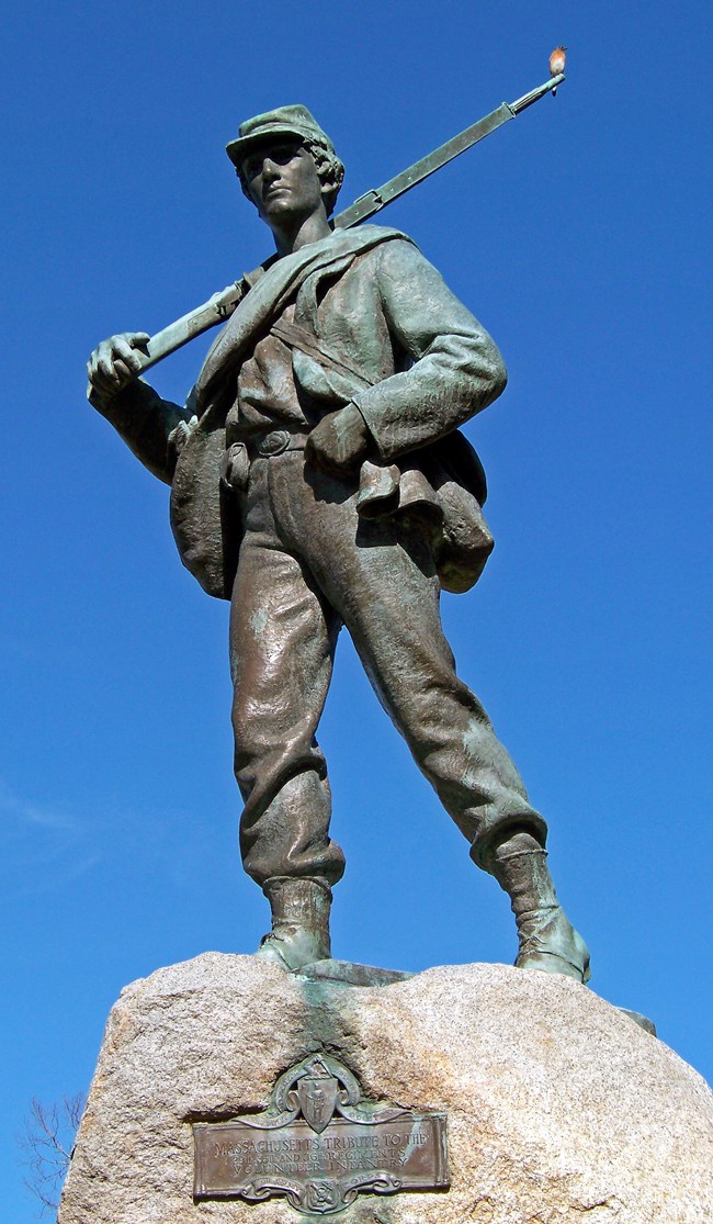 A bronze sculpture of a solider
