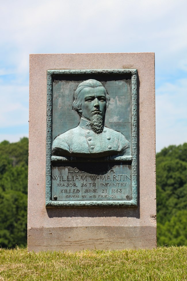 A bronze relief portrait of a man in uniform