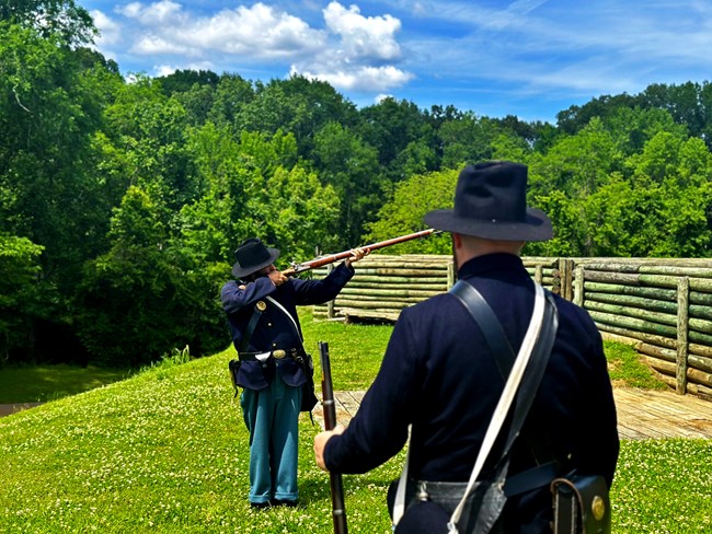 Two rangers in period Civil War uniform demonstrate proper infantry drill for firing