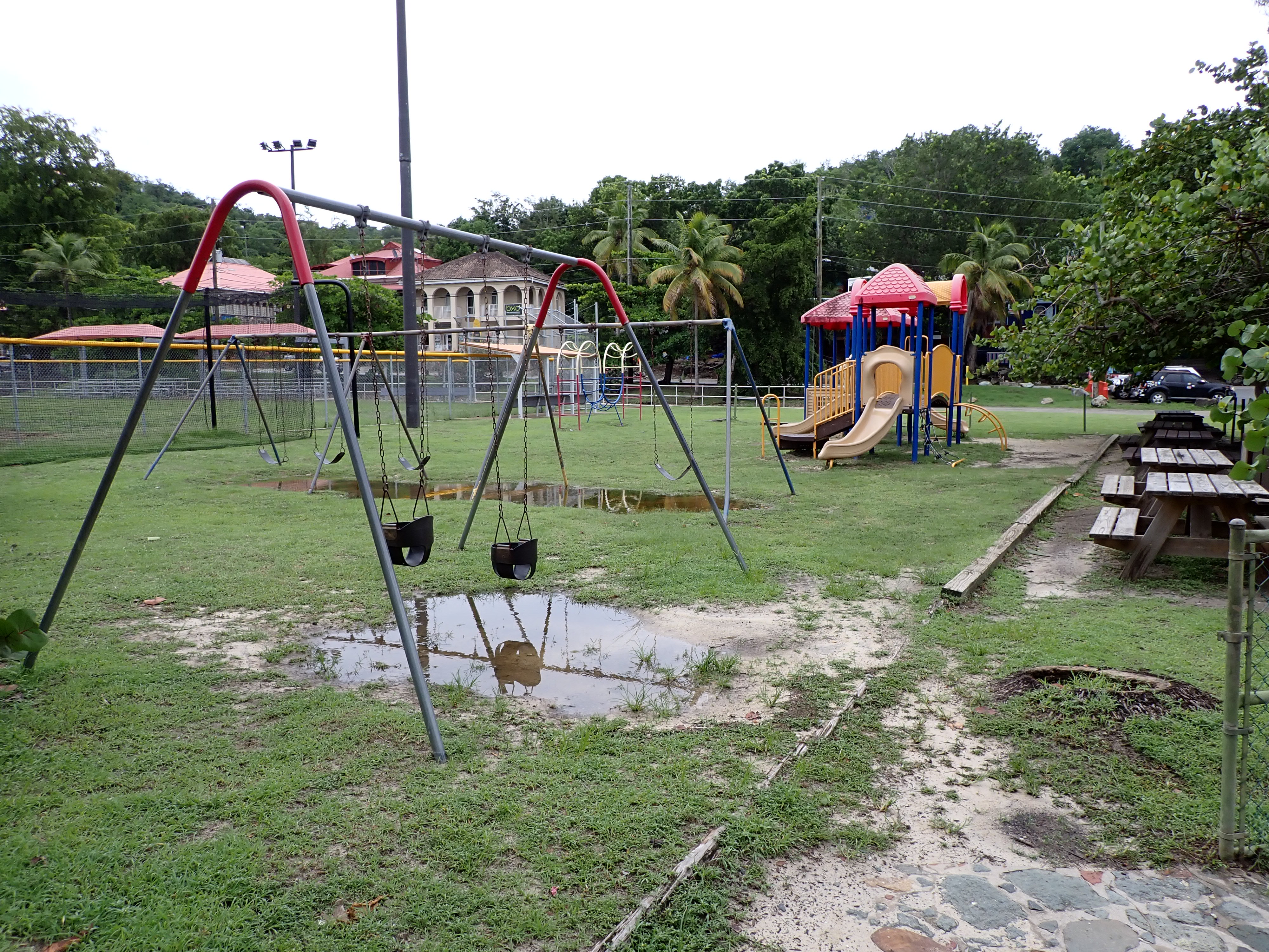 The Cruz Bay playground with swingsets, slides, and climbing bars.