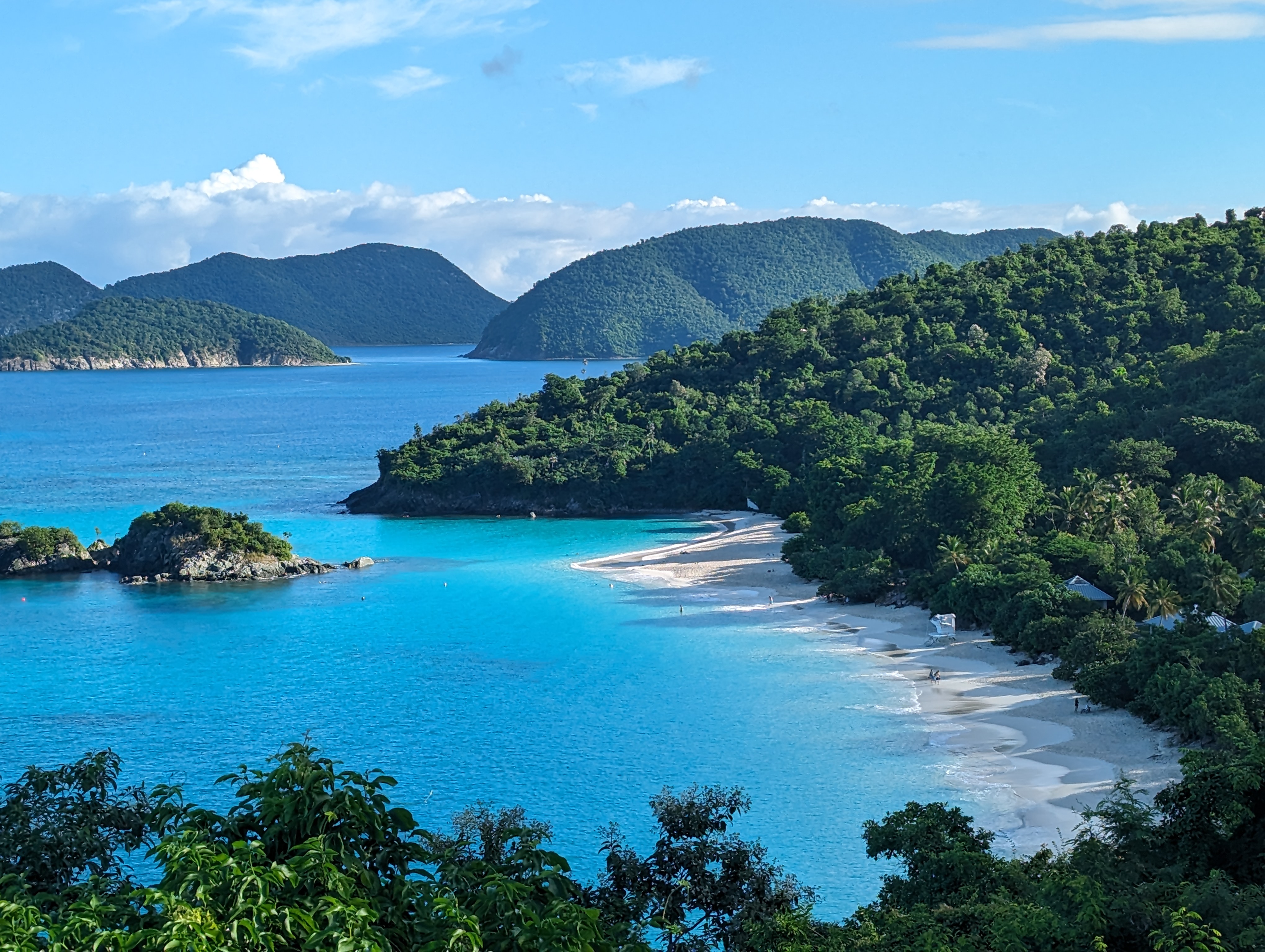 Image of Trunk Bay with white sand and blue water and sky.