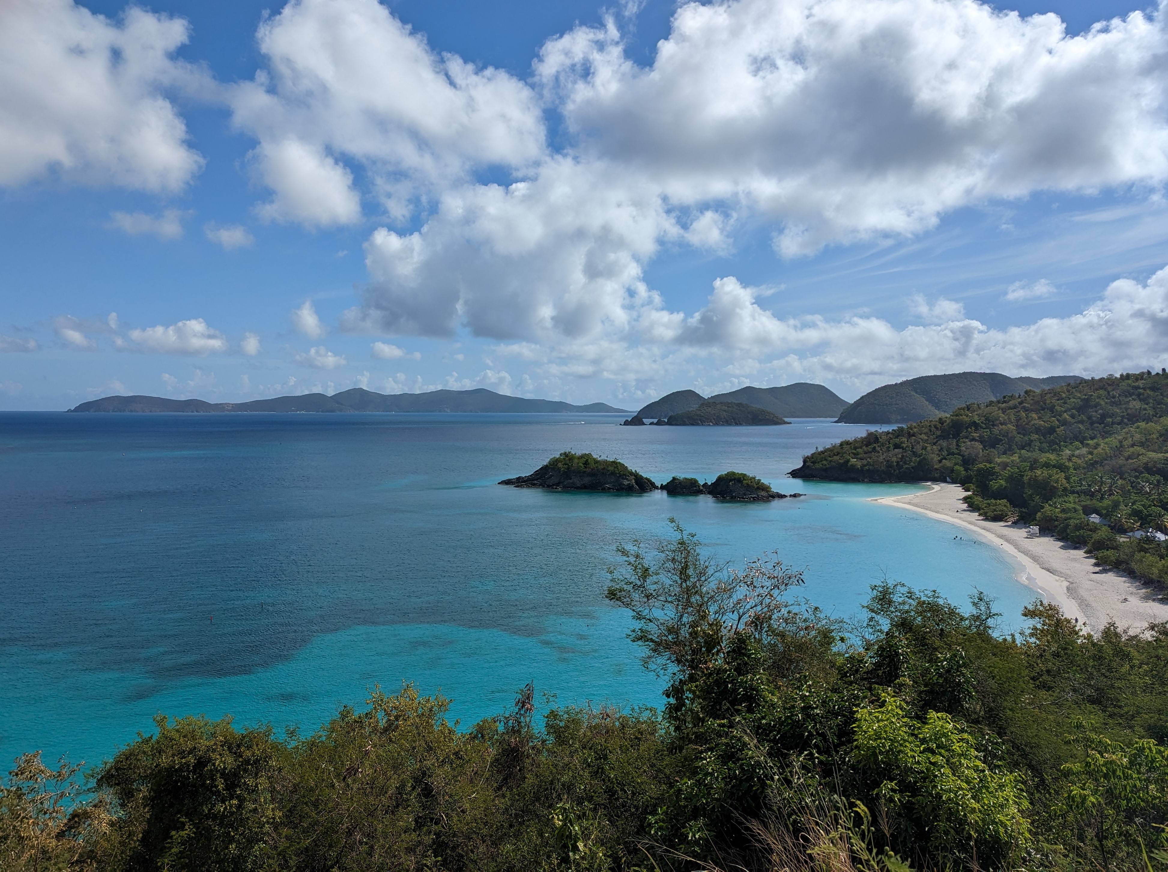 Image of white sand and blue water of Trunk Bay.