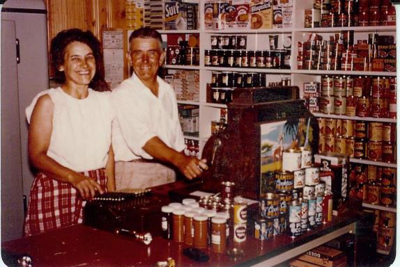 Historic photo of Ted and Fern Monson standing next to a register at their resort in Hoist Bay.