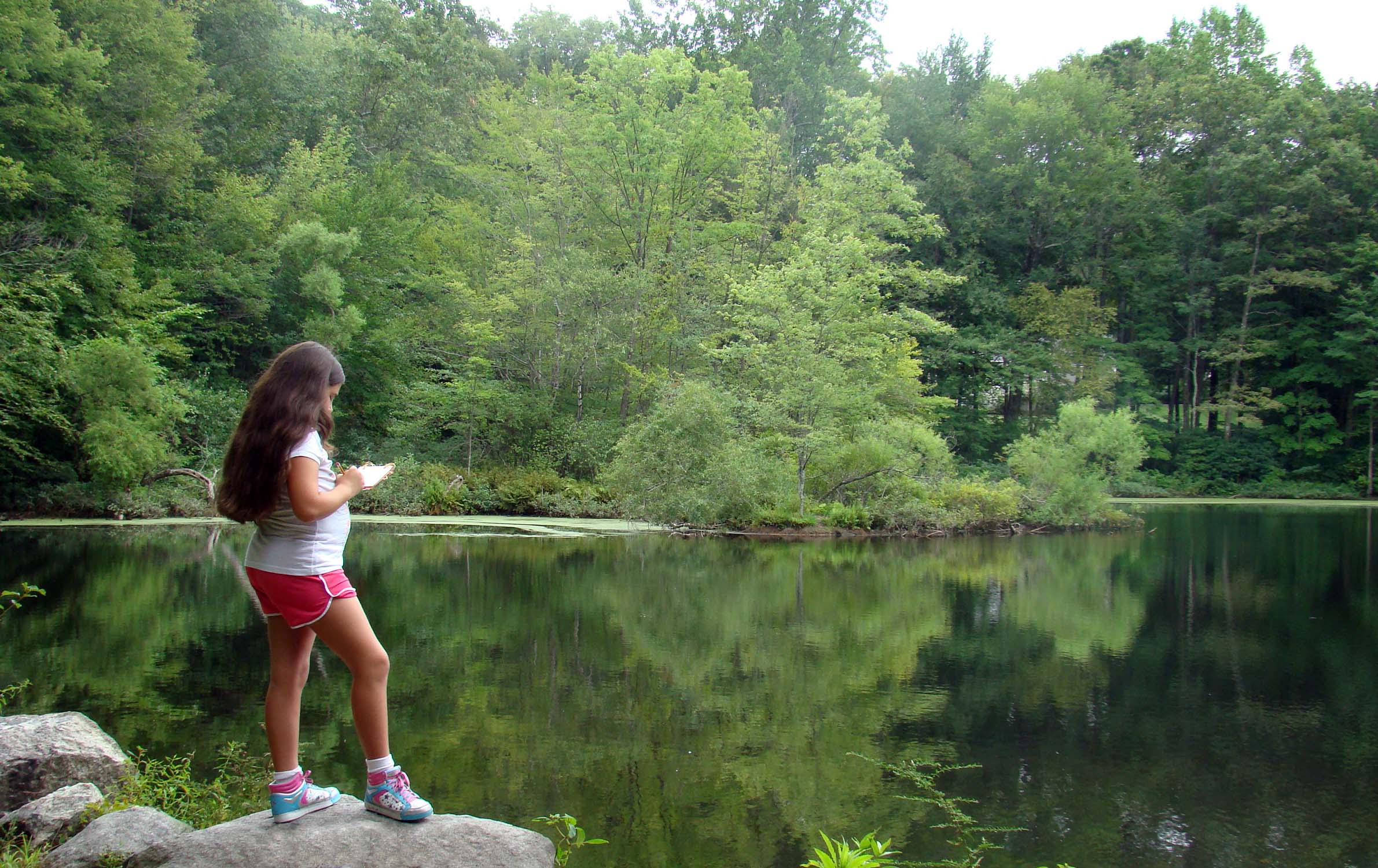 A young visitor enjoys solitude at Weir Pond