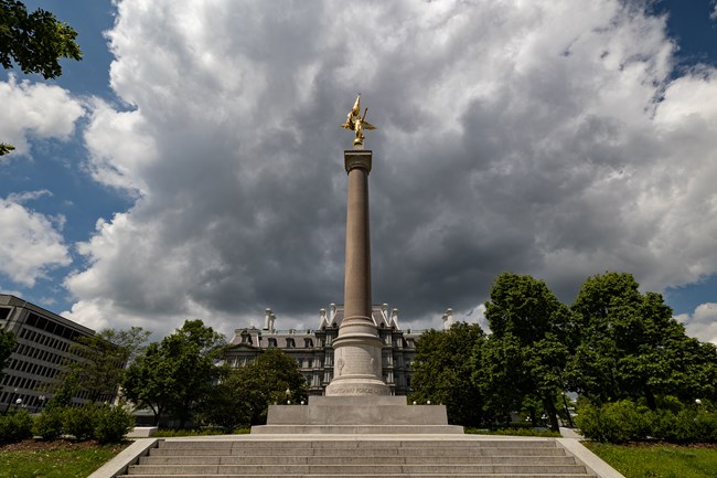 WHHO_Monuments_20250515_KGraczyk_014 A golden, winged figure tops a tall marble column.