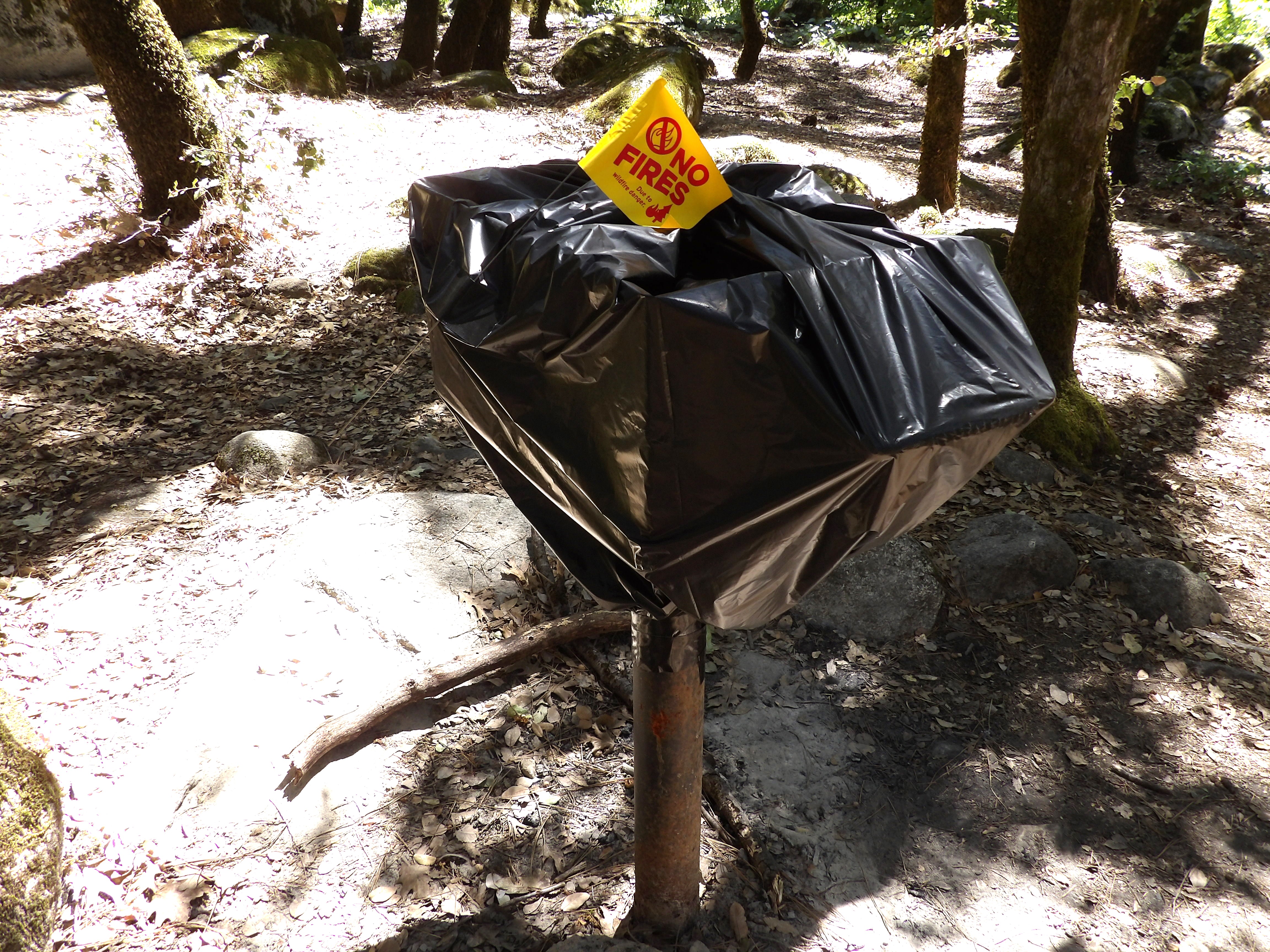 Picnic grill at Brandy Creek Beach temporarily covered and closed.