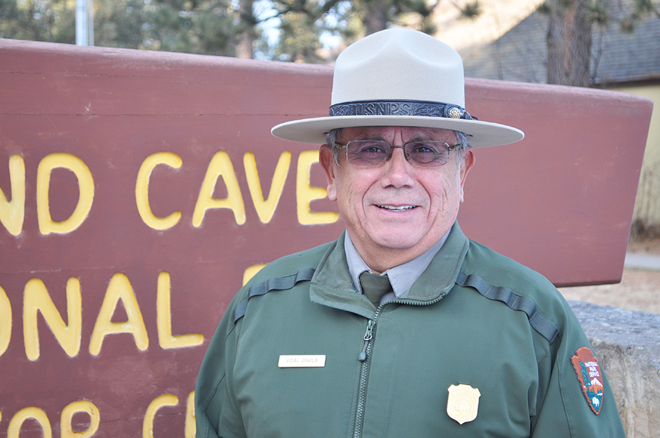 Vidal Davila standing by park sign.