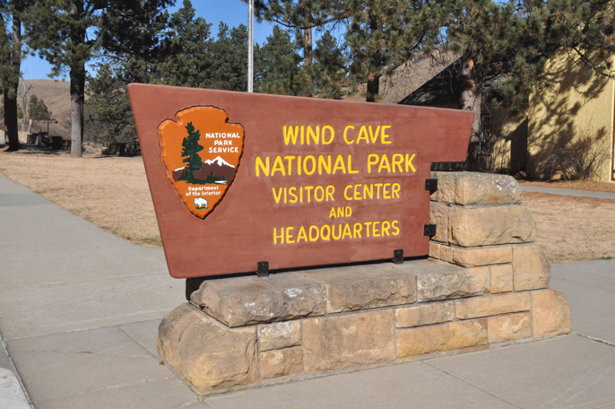 Wooden entance sign out front of the visitor center.