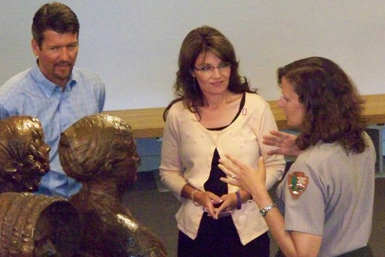 Governor Palin listens to park superintendent Orcutt explain who organized the First Woman's Rights Convention. They are standing next to life-size statues.