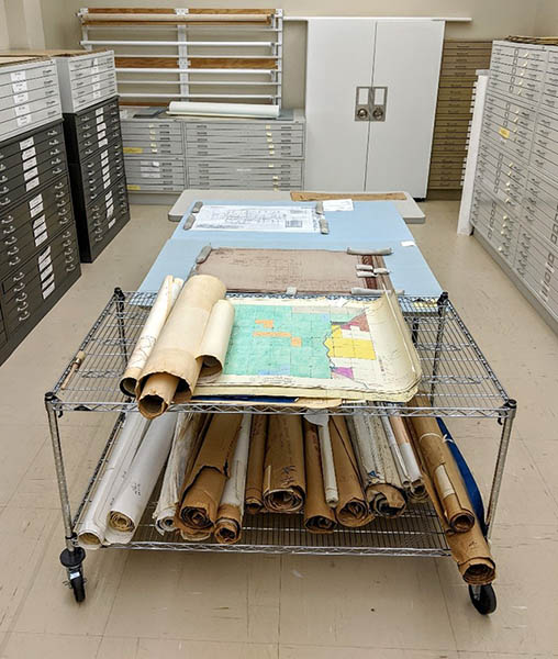 Cart containing rolled maps and drawings
