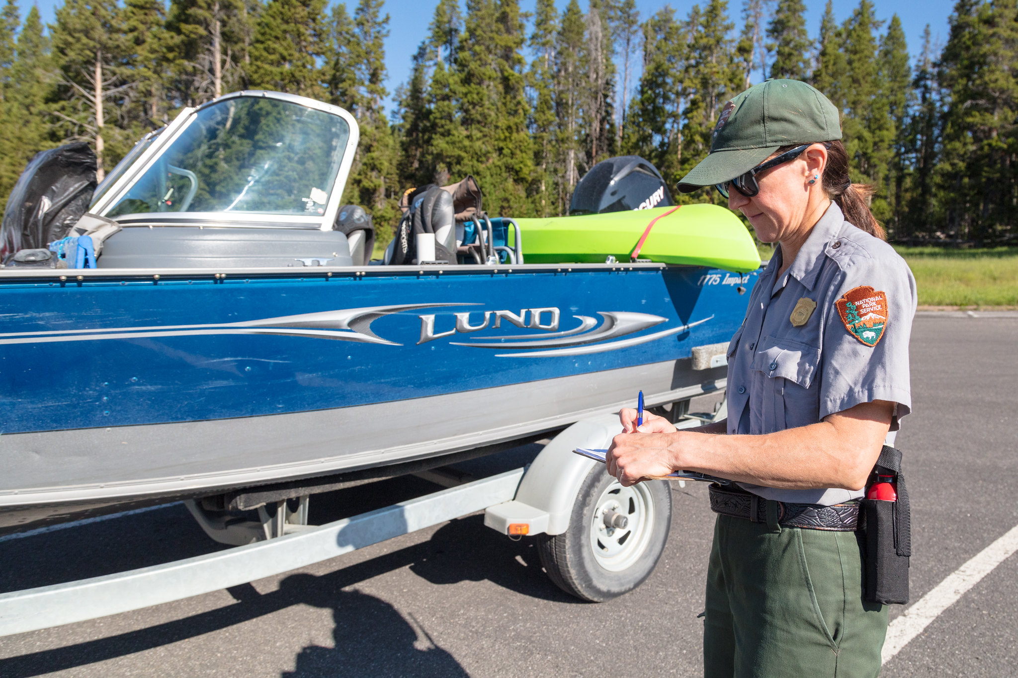 ranger fills out paperwork during boat inspection