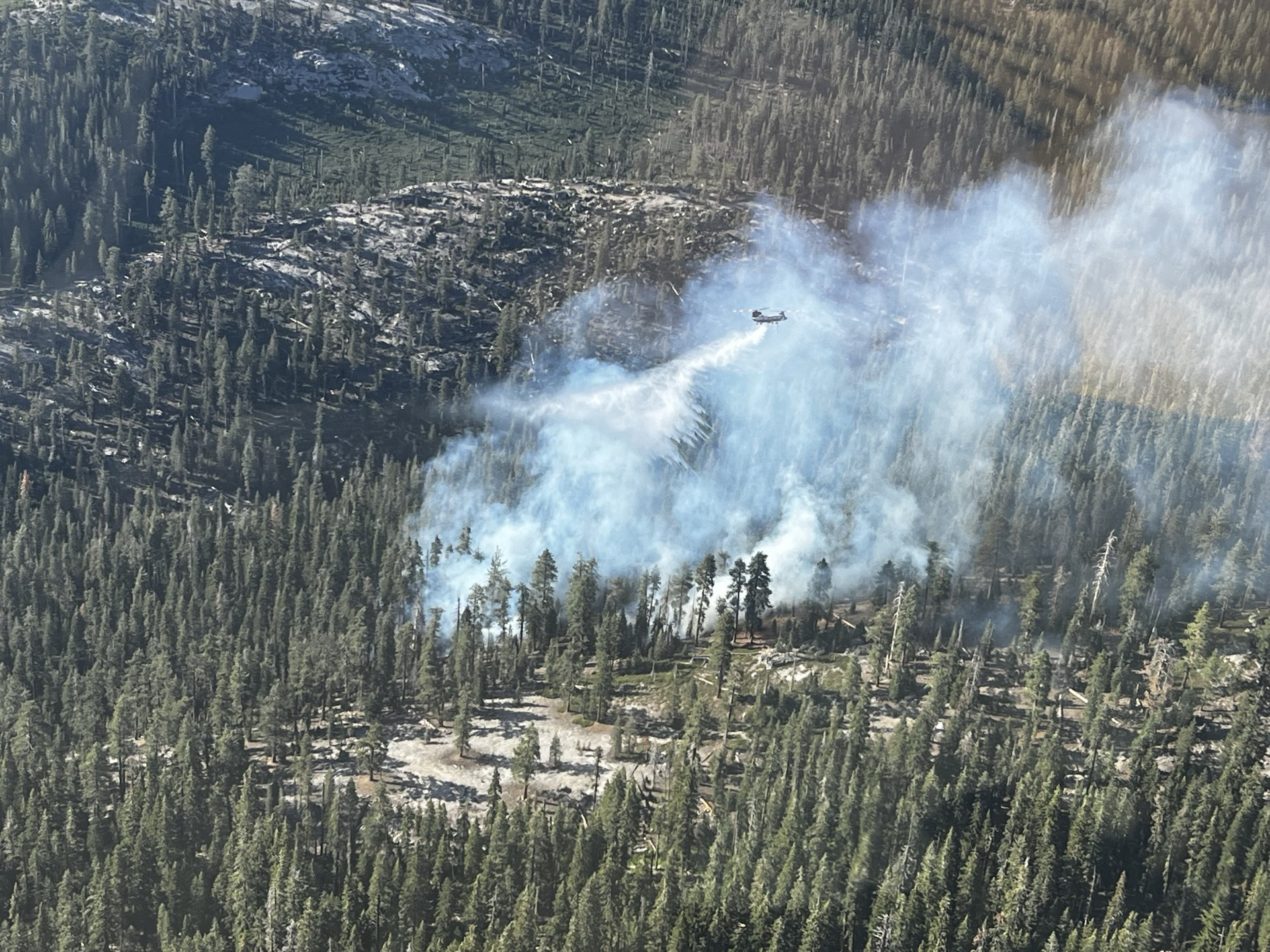 Helicopter dropping a bucket of water on Middle Fire
