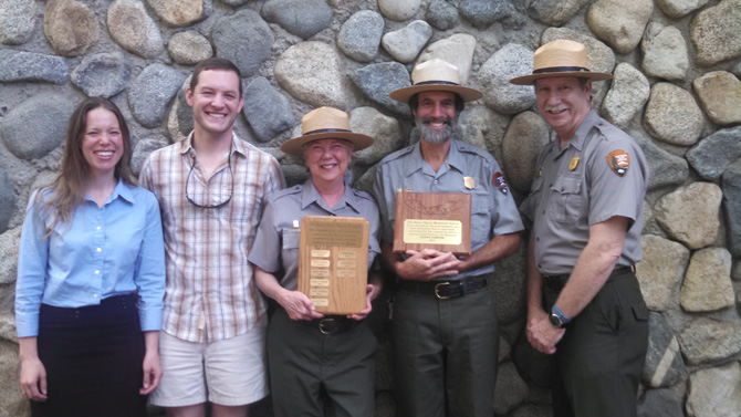 Glenn Gibbons, pictured in uniform holding the plaque, is joined by fellow Yosemite National Park employees. Yosemite National Park Superintendent Don Neubacher is at the far right.