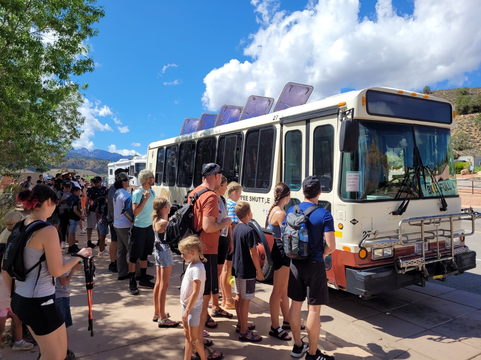 A long line of people waiting for the Zion shuttle