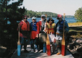 Park volunteers stand with canoe paddles in hand after leading a guided North Canoe trip in the park.